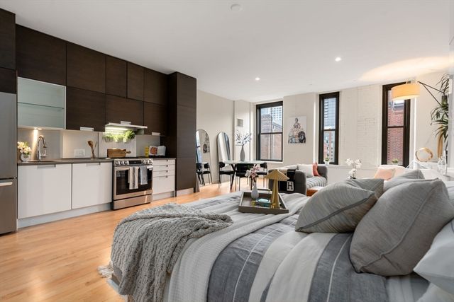 a large bedroom with bed and window