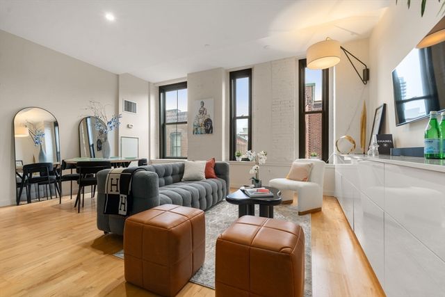 a living room with furniture and large windows