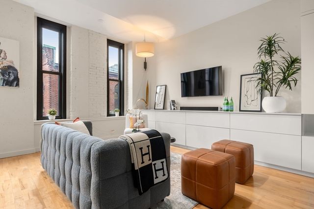 a bedroom with furniture and a flat screen tv