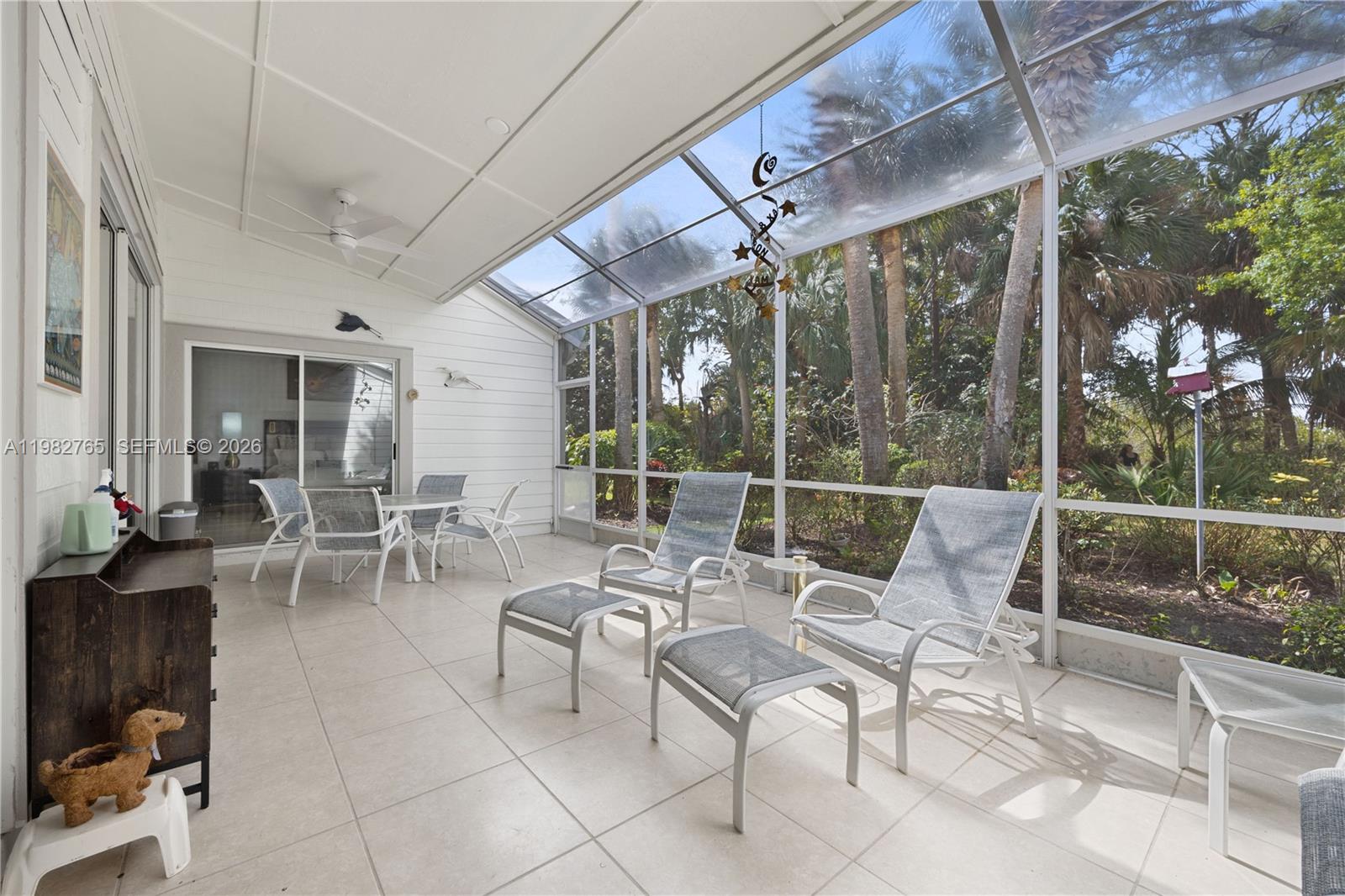8962 Southeast Riverfront Terrace Jupiter, FL 33469 - Photo 13 of 20 a view of a patio with a dining table and chairs
