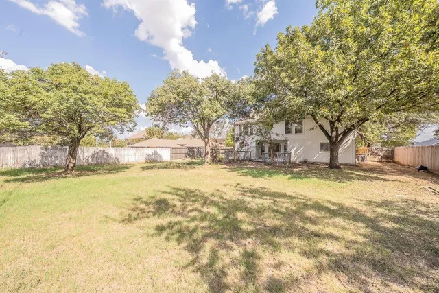 a view of a house with a yard and sitting area