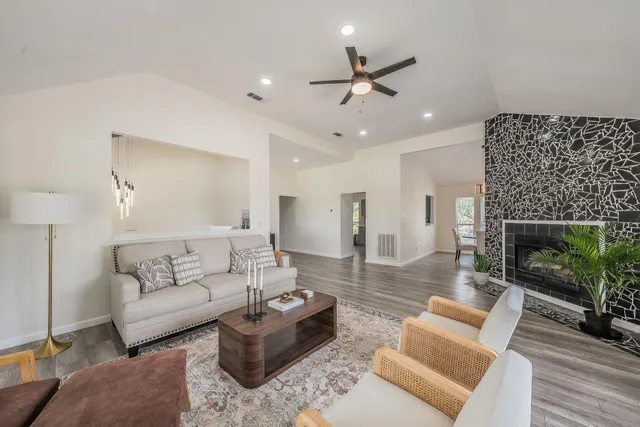 a living room with furniture and a fireplace