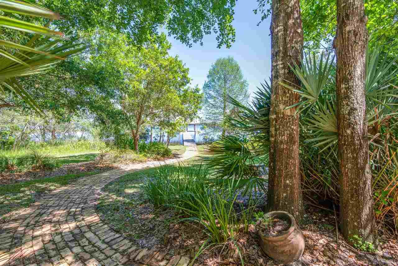 7636 Old Bay Pointe Road Milton, FL 32583 - Photo 3 of 50 Stroll through luscious landscape on way to dock