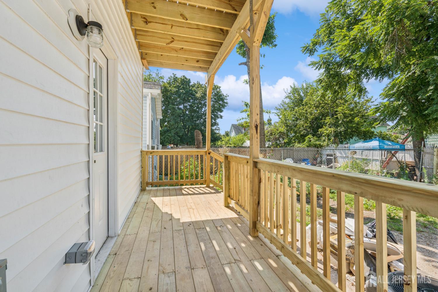 318 Seaman Street, Unit 1 New Brunswick, NJ 08901 - Photo 11 of 14 a view of a balcony with wooden floor