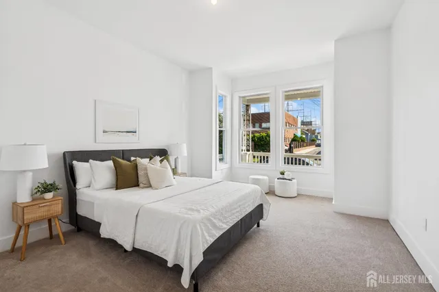 a spacious bedroom with a bed and window