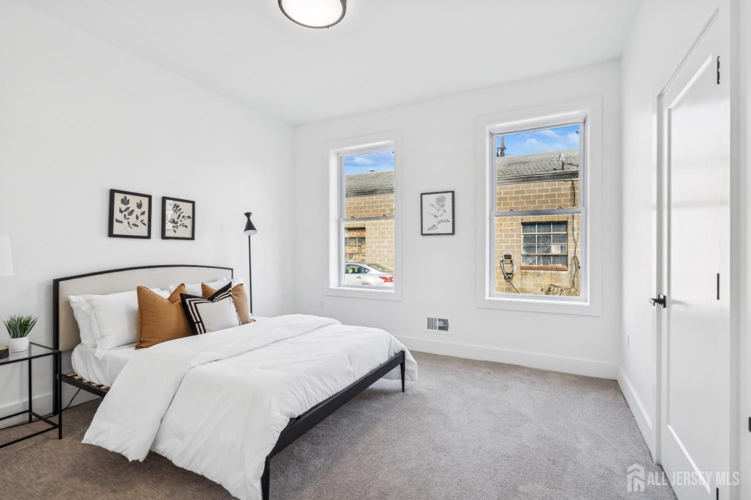 318 Seaman Street, Unit 1 New Brunswick, NJ 08901 - Photo 3 of 14 a bedroom with a bed and a window