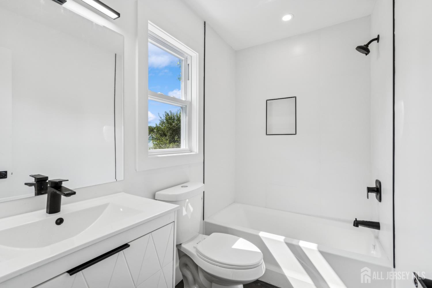 318 Seaman Street, Unit 1 New Brunswick, NJ 08901 - Photo 10 of 14 a bathroom with a sink toilet and shower
