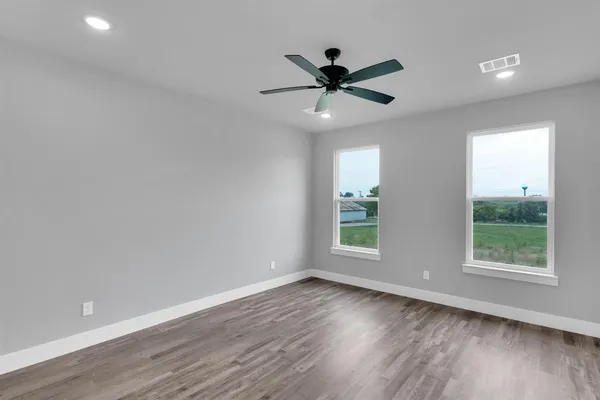 a view of an empty room and wooden floor