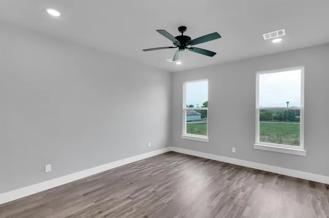 a view of an empty room and wooden floor