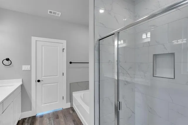 a bathroom with a bathtub and a shower