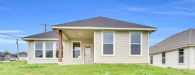 a front view of a house with a garden and yard
