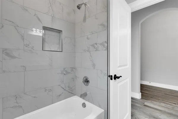 a bathroom with a bathtub and shower