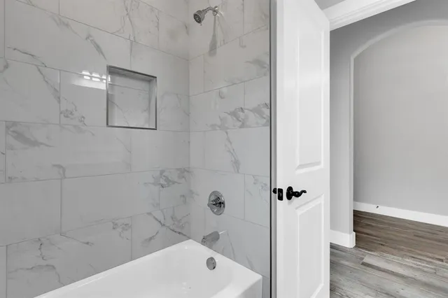 a bathroom with a bathtub and shower