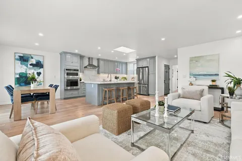 a living room with furniture and kitchen view