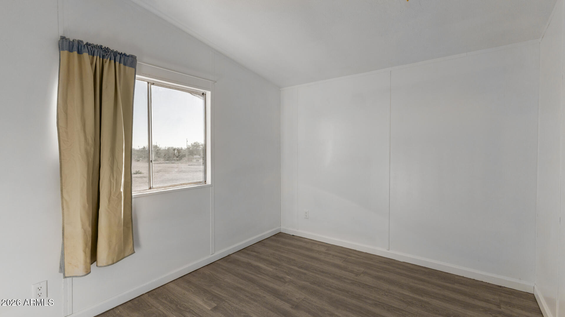 54073 West Stallion Road Maricopa, AZ 85139 - Photo 12 of 23 a view of an empty room with wooden floor and a window