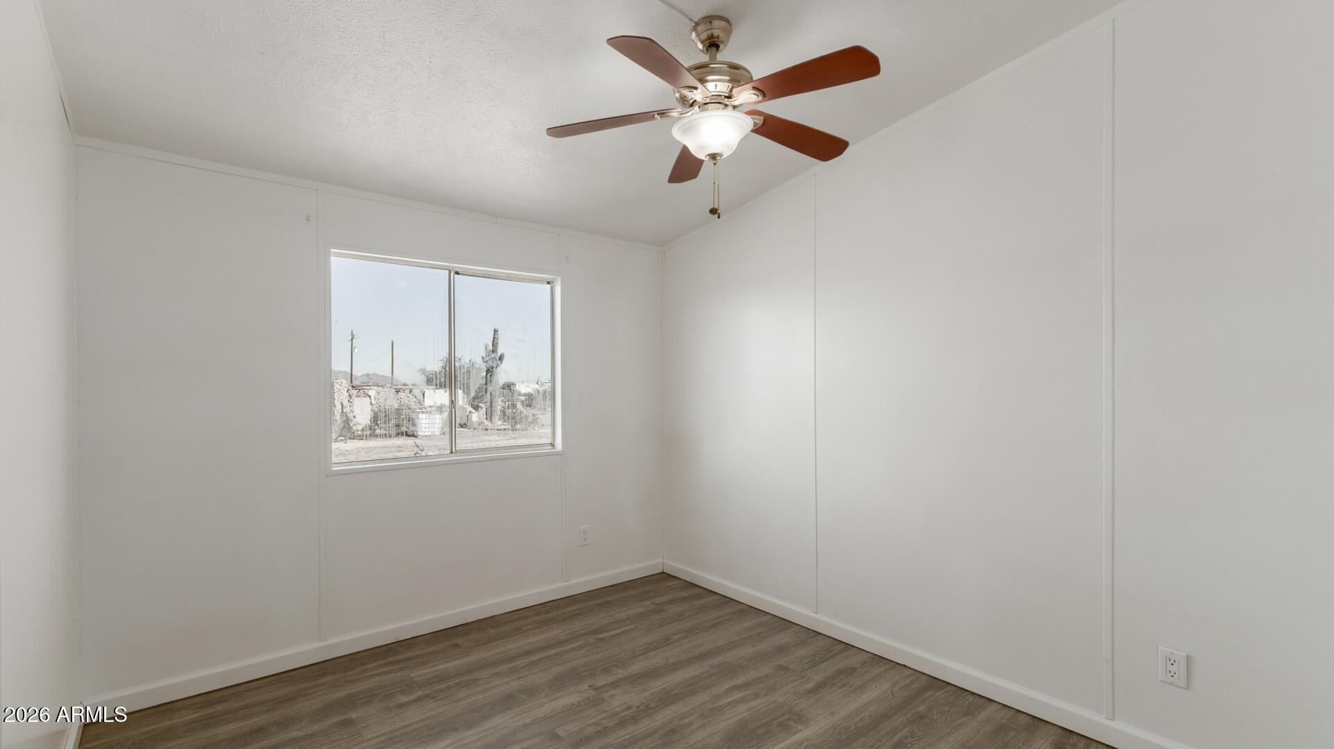 54073 West Stallion Road Maricopa, AZ 85139 - Photo 15 of 23 an empty room with a window and a fan