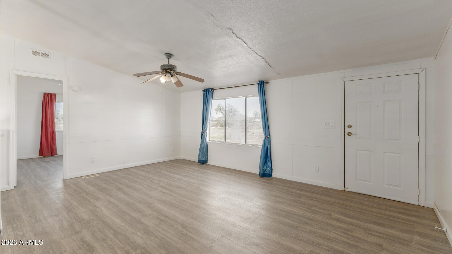 54073 West Stallion Road Maricopa, AZ 85139 - Photo 4 of 23 an empty room with fan and windows