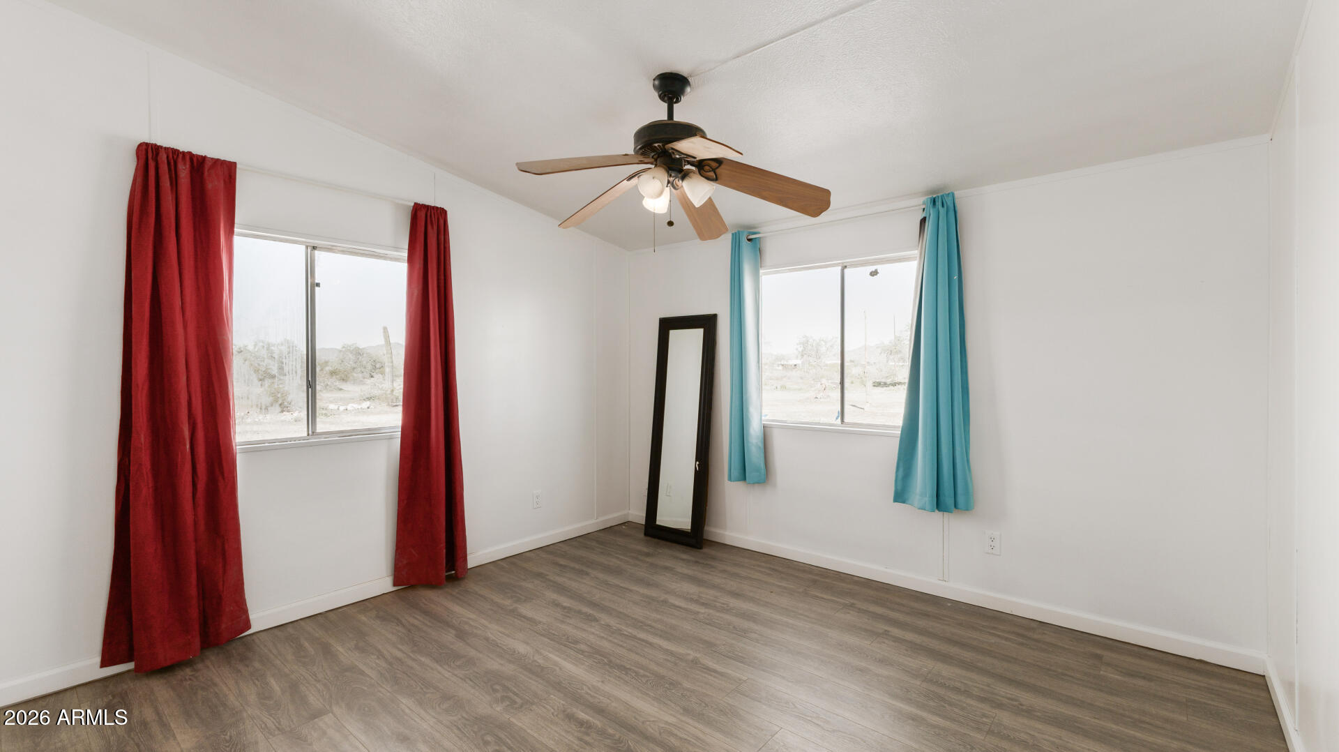54073 West Stallion Road Maricopa, AZ 85139 - Photo 9 of 23 a view of empty room with wooden floor and fan