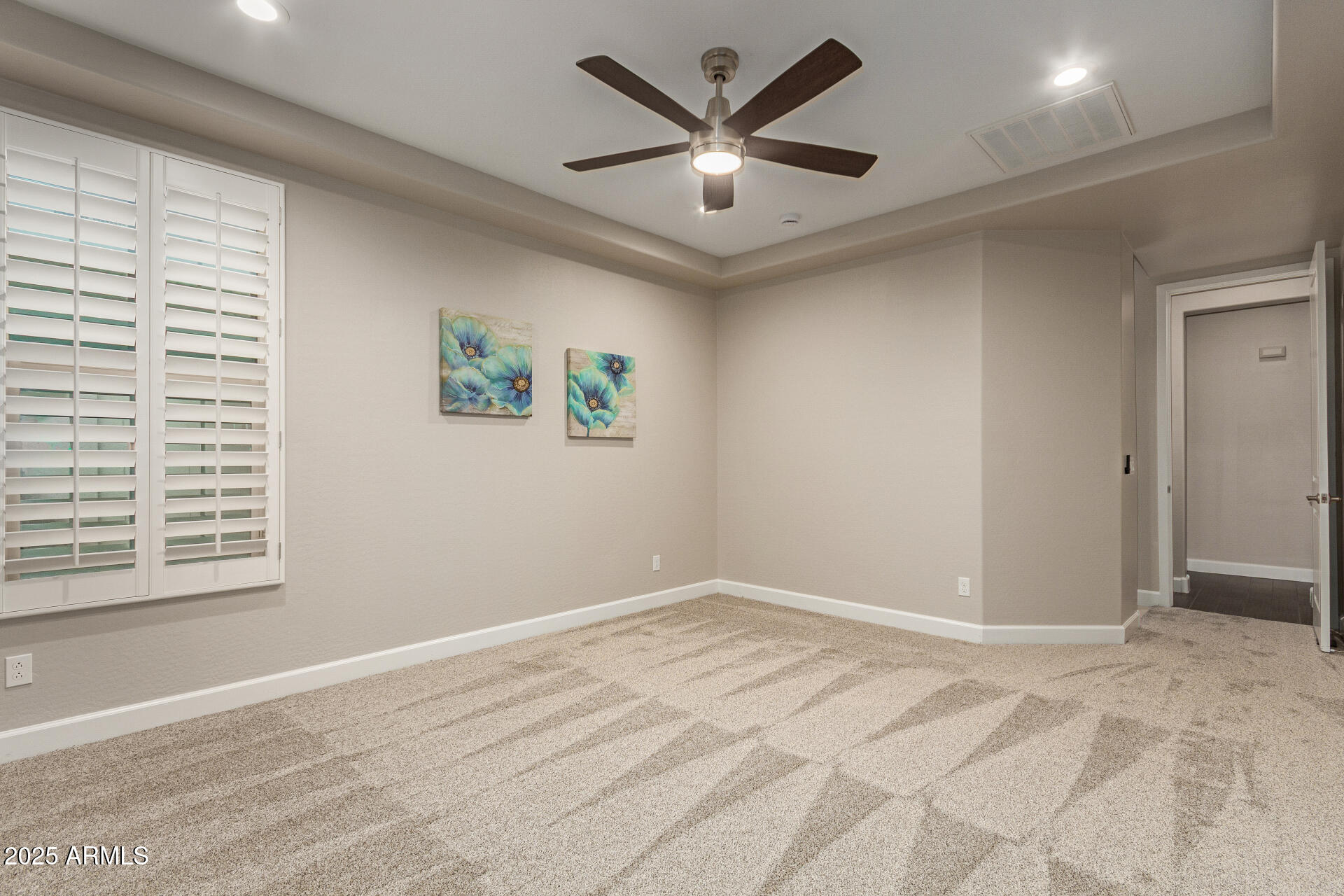 4312 East Rawhide Street Gilbert, AZ 85296 - Photo 12 of 24 a view of a big room with wooden floor and a ceiling fan