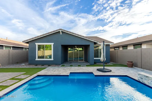 a house view with swimming pool and porch
