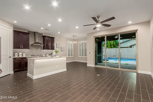 a view of kitchen with granite countertop cabinets and wooden floor