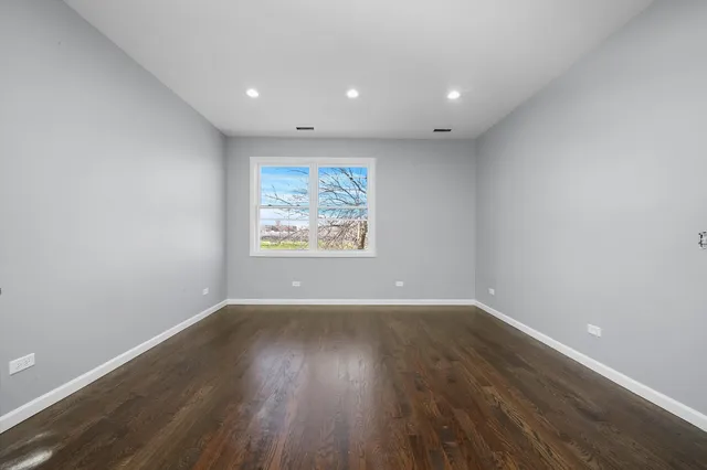a kitchen with appliances a refrigerator a sink and cabinets