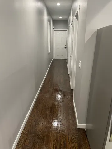 a large kitchen with stainless steel appliances a large counter top and a stove top oven