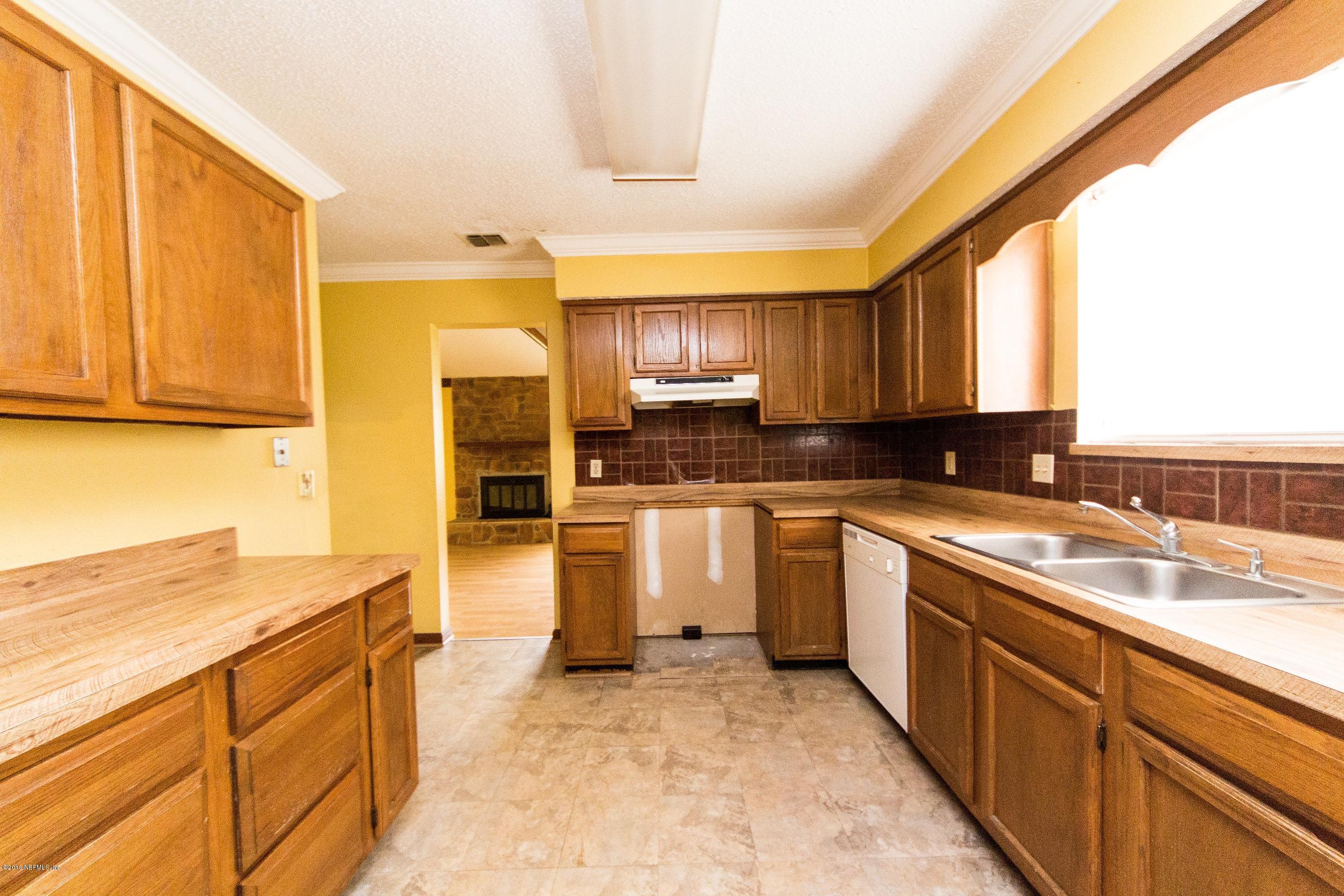 10852 Reading Road Jacksonville, FL 32257 - Photo 13 of 30 a kitchen with granite countertop a sink cabinets stainless steel appliances and a window