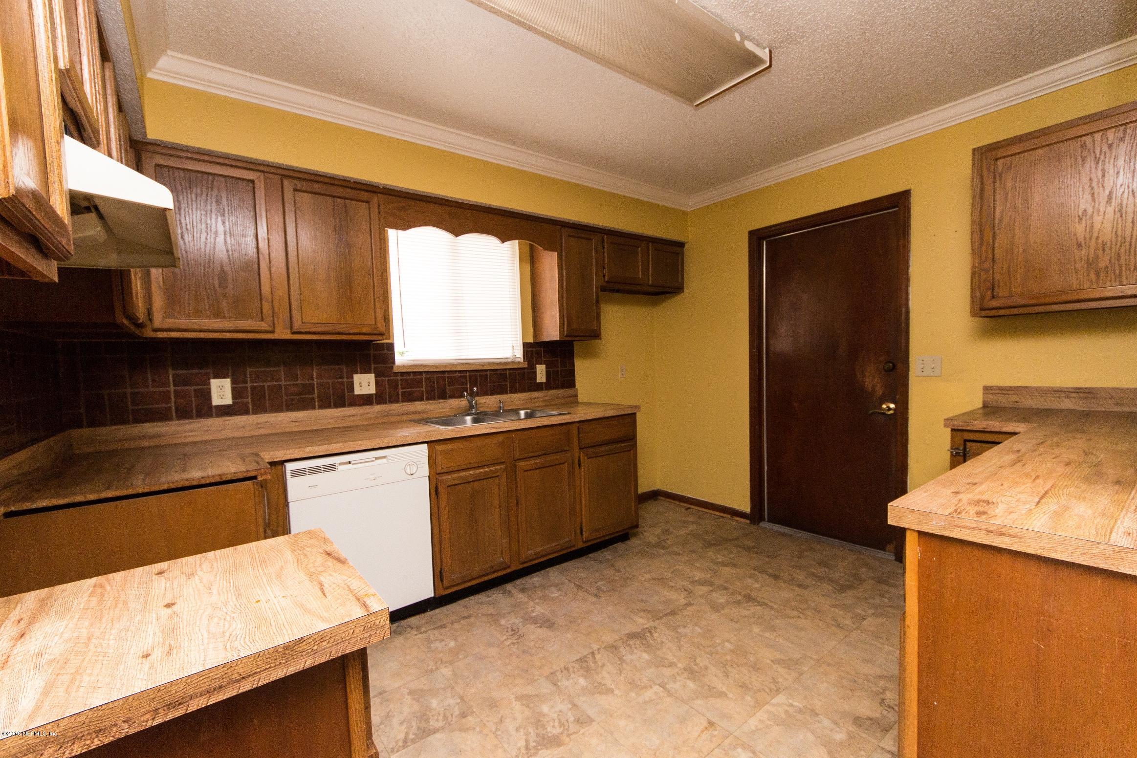 10852 Reading Road Jacksonville, FL 32257 - Photo 15 of 30 a kitchen with granite countertop wooden cabinets and a stove