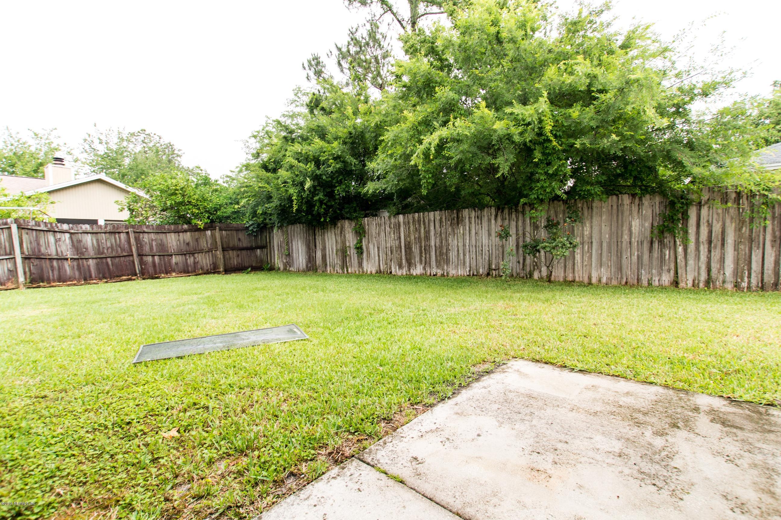 10852 Reading Road Jacksonville, FL 32257 - Photo 25 of 30 a view of a backyard with a garden and trees