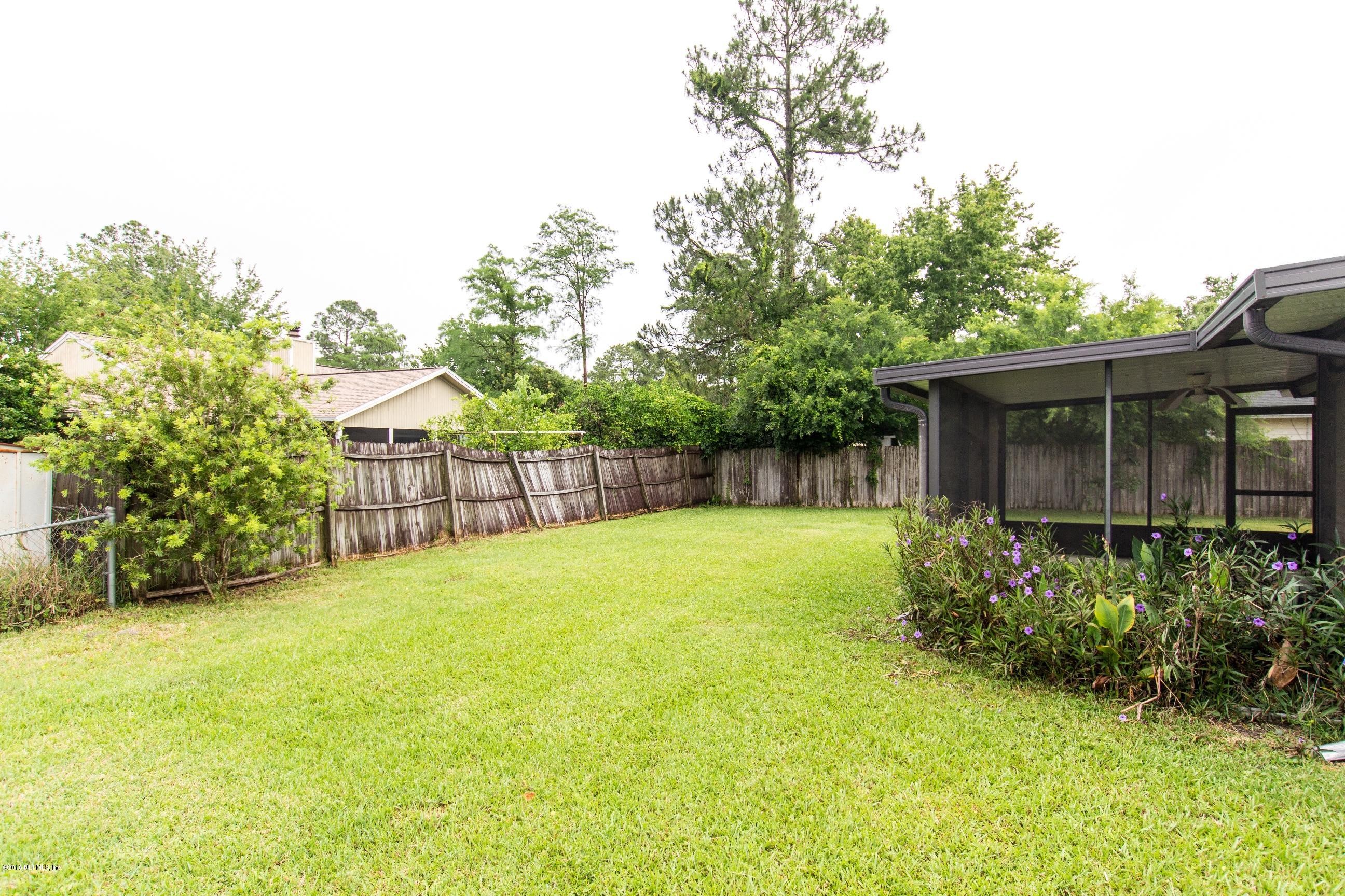 10852 Reading Road Jacksonville, FL 32257 - Photo 26 of 30 a view of a backyard with plants and large trees