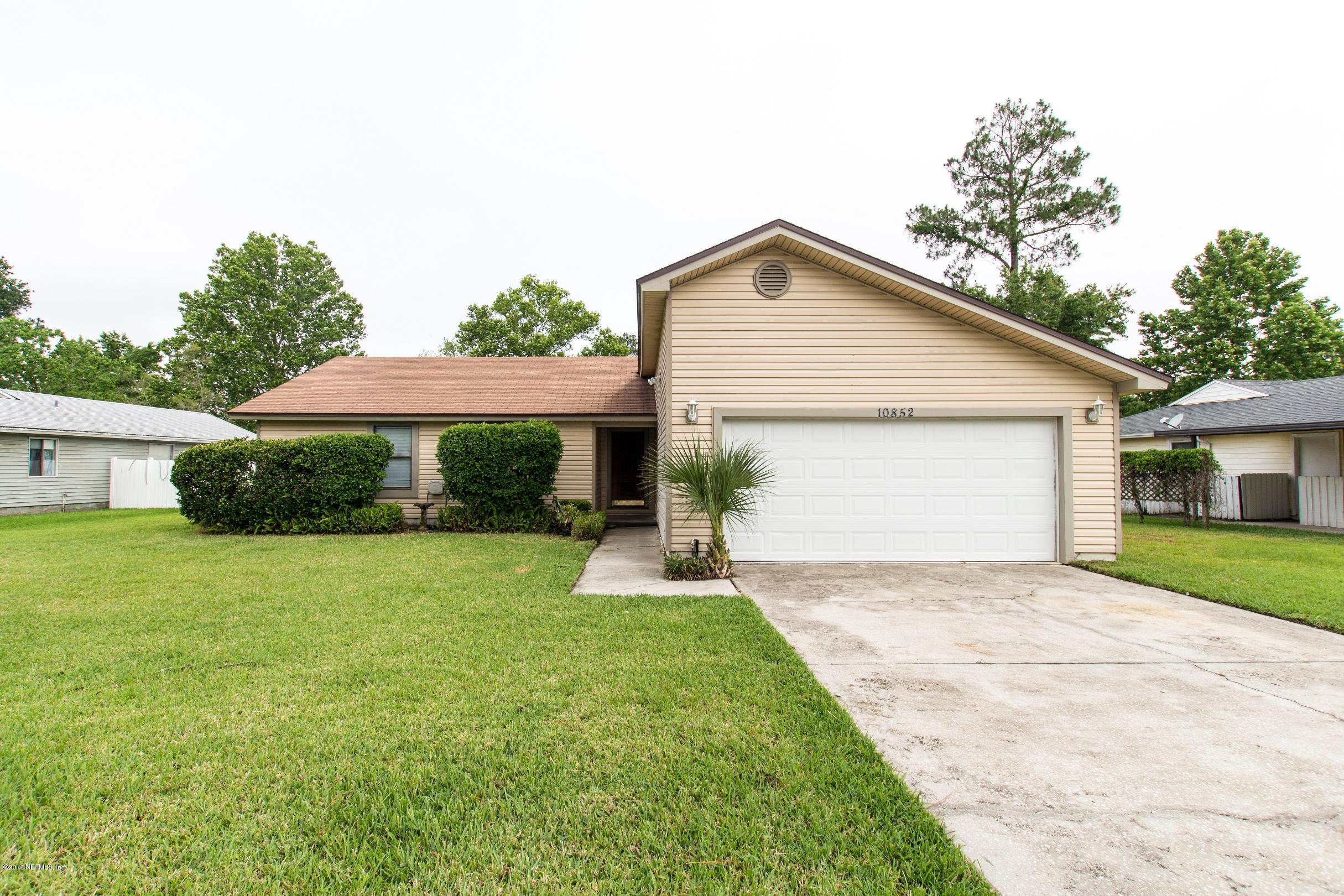 10852 Reading Road Jacksonville, FL 32257 - Photo 3 of 30 a view of a house with a yard and garage