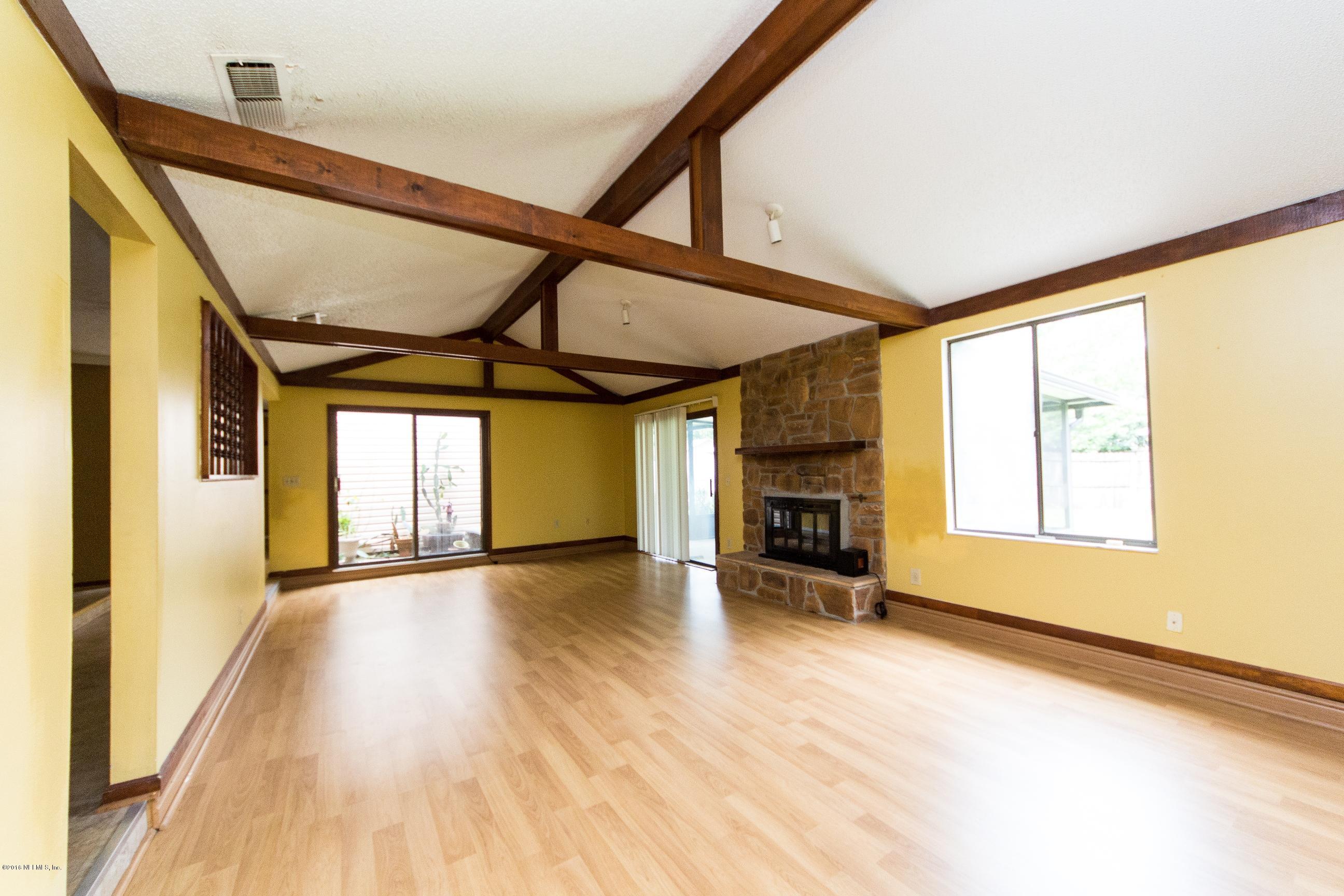 10852 Reading Road Jacksonville, FL 32257 - Photo 7 of 30 a view of an empty room with a window and wooden floor
