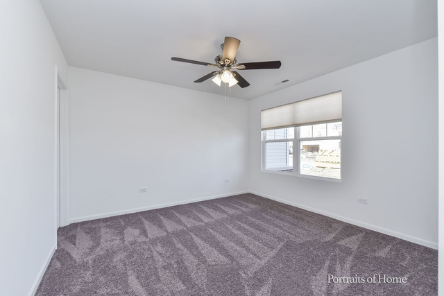 4189 Chelsea Manor Circle Aurora, IL 60504 - Photo 11 of 19 an empty room with windows and fan