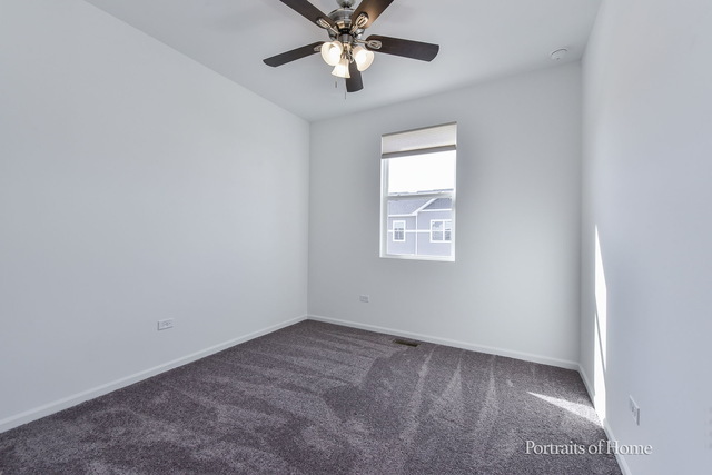 4189 Chelsea Manor Circle Aurora, IL 60504 - Photo 13 of 19 an empty room with closet and a chandelier fan