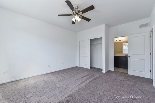 4189 Chelsea Manor Circle Aurora, IL 60504 - Photo 3 of 19 an empty room with closet and windows