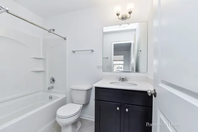 a bathroom with a sink toilet vanity and shower