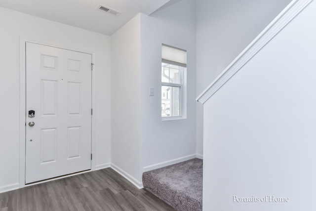 4189 Chelsea Manor Circle Aurora, IL 60504 - Photo 5 of 19 a view of an empty room with wooden floor and a window