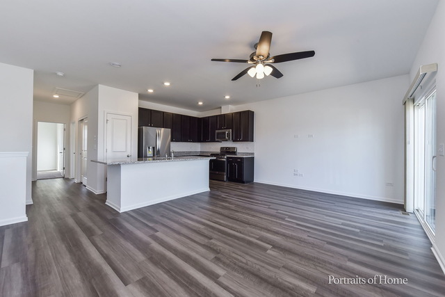 4189 Chelsea Manor Circle Aurora, IL 60504 - Photo 7 of 19 a view of kitchen with refrigerator microwave and stove