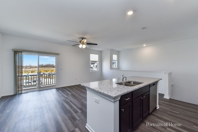 4189 Chelsea Manor Circle Aurora, IL 60504 - Photo 10 of 19 a kitchen with a sink cabinets and wooden floor