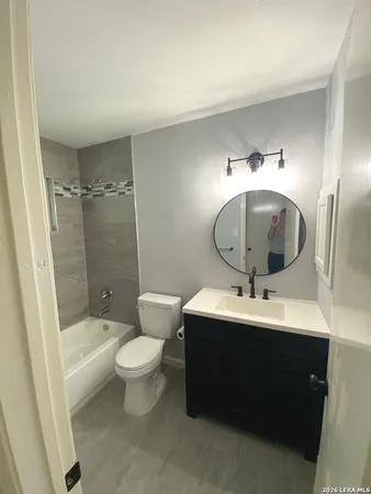 a bathroom with a toilet and a bath tub