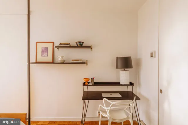 a bedroom with a bed and glass door