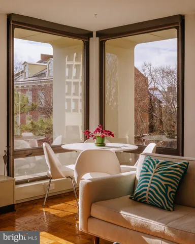 a living room with a large window and a table