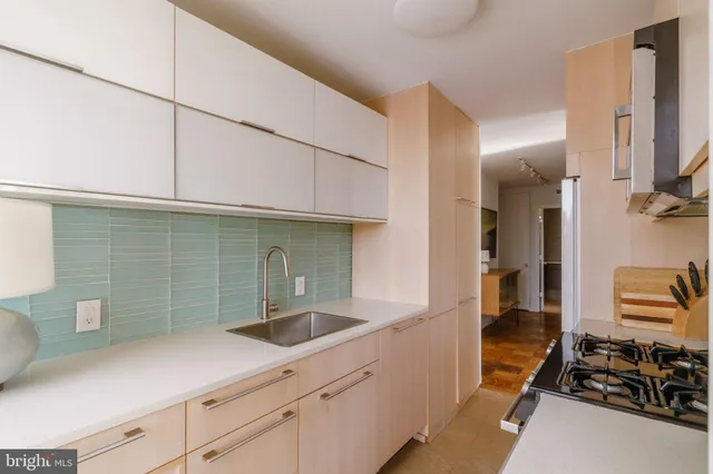 a kitchen with a sink and cabinets