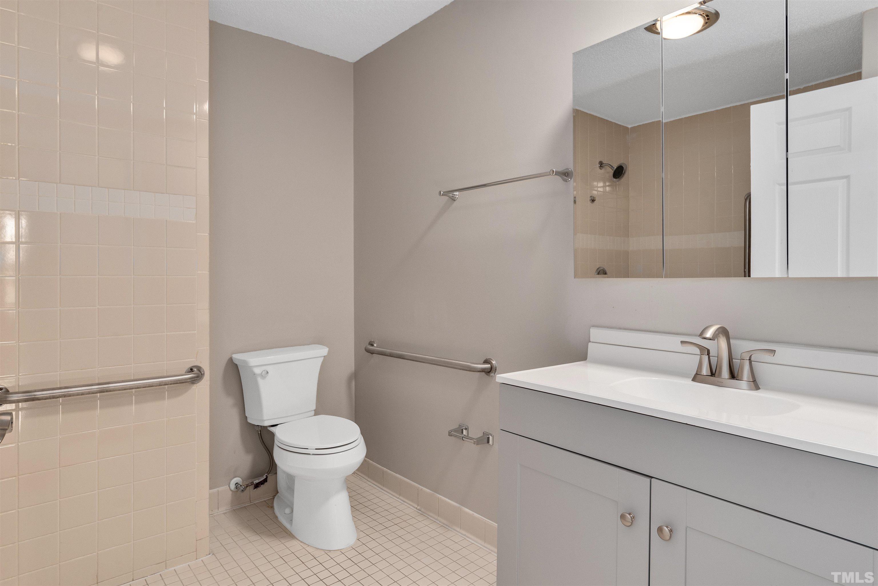 5630 Fairground Road Dunn, NC 28334 - Photo 15 of 33 a bathroom with a toilet sink and mirror