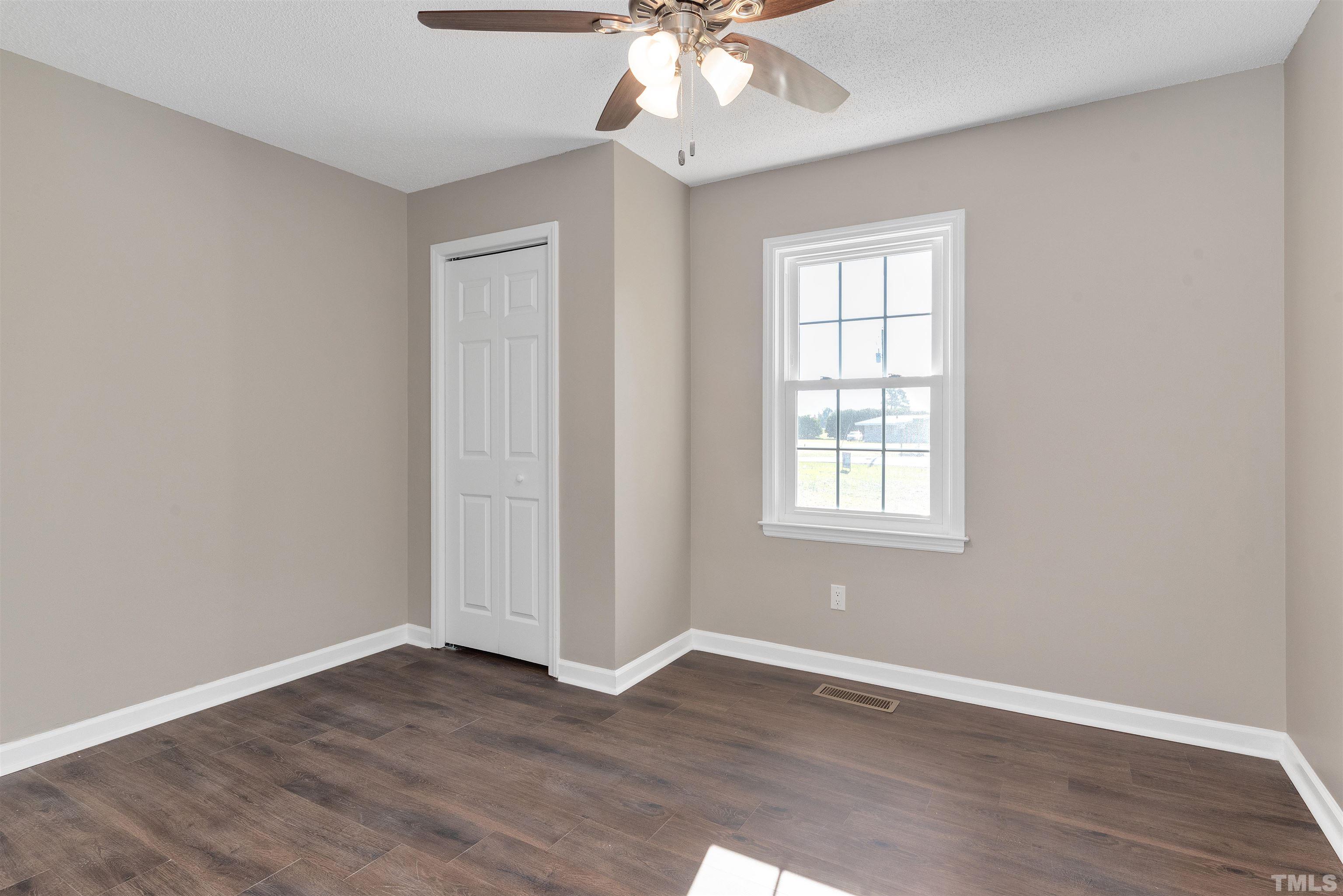 5630 Fairground Road Dunn, NC 28334 - Photo 17 of 33 a view of an empty room with wooden floor and a window