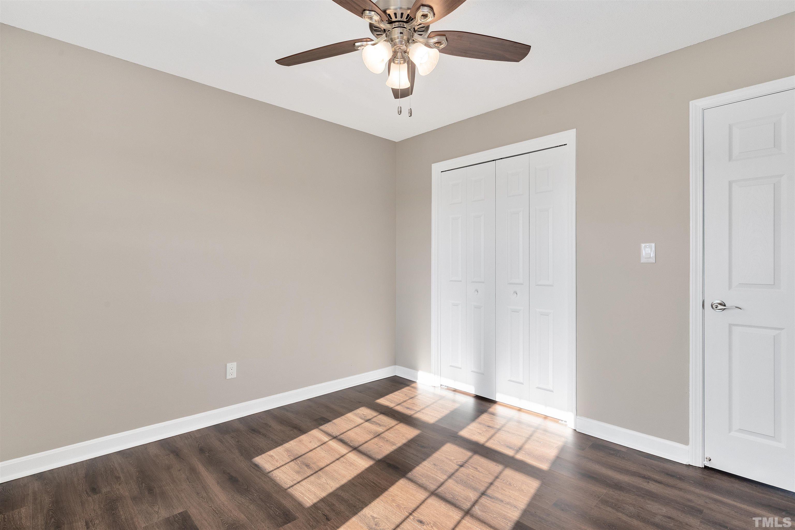 5630 Fairground Road Dunn, NC 28334 - Photo 20 of 33 an empty room with wooden floor and windows