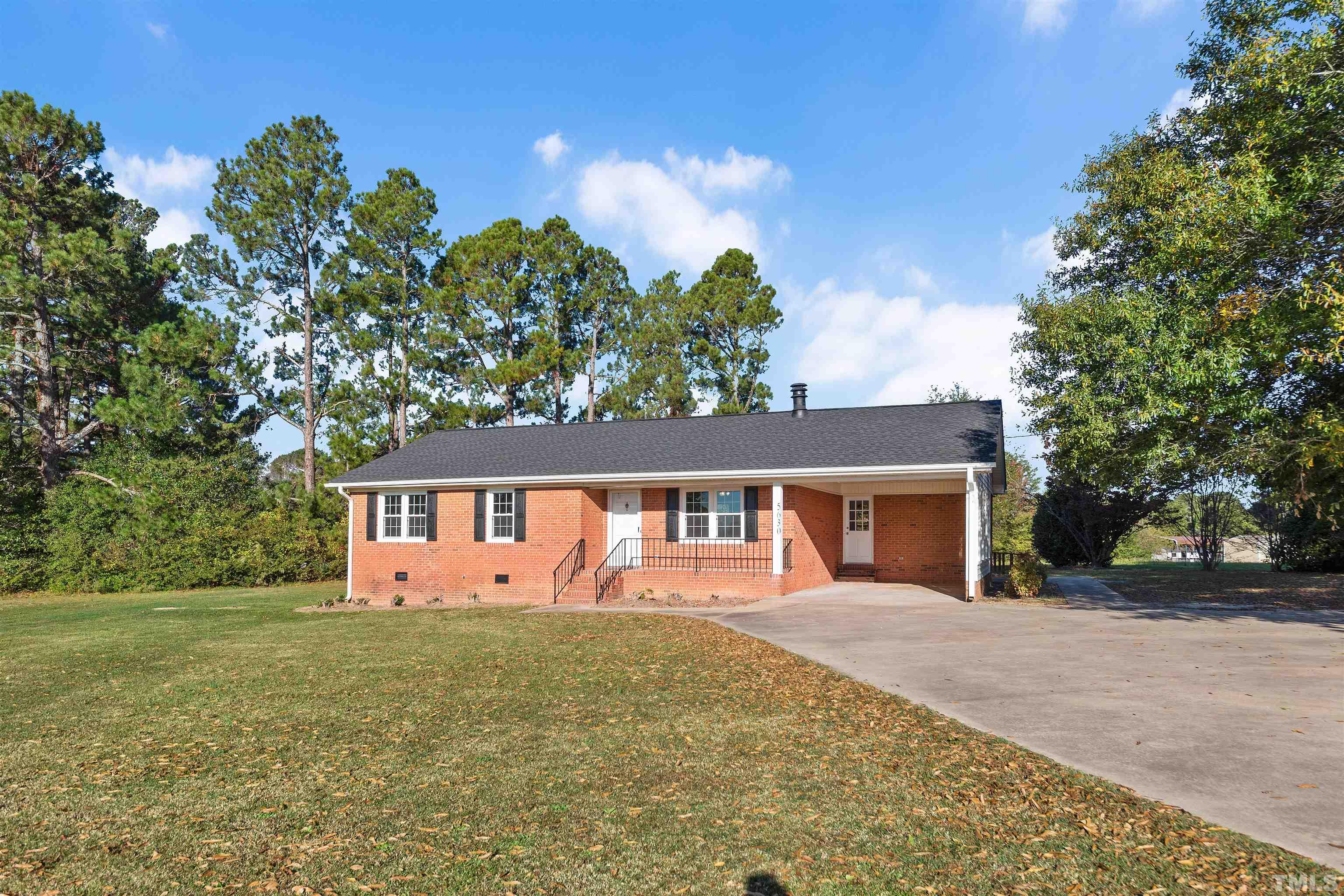 5630 Fairground Road Dunn, NC 28334 - Photo 26 of 33 a front view of a house with garden