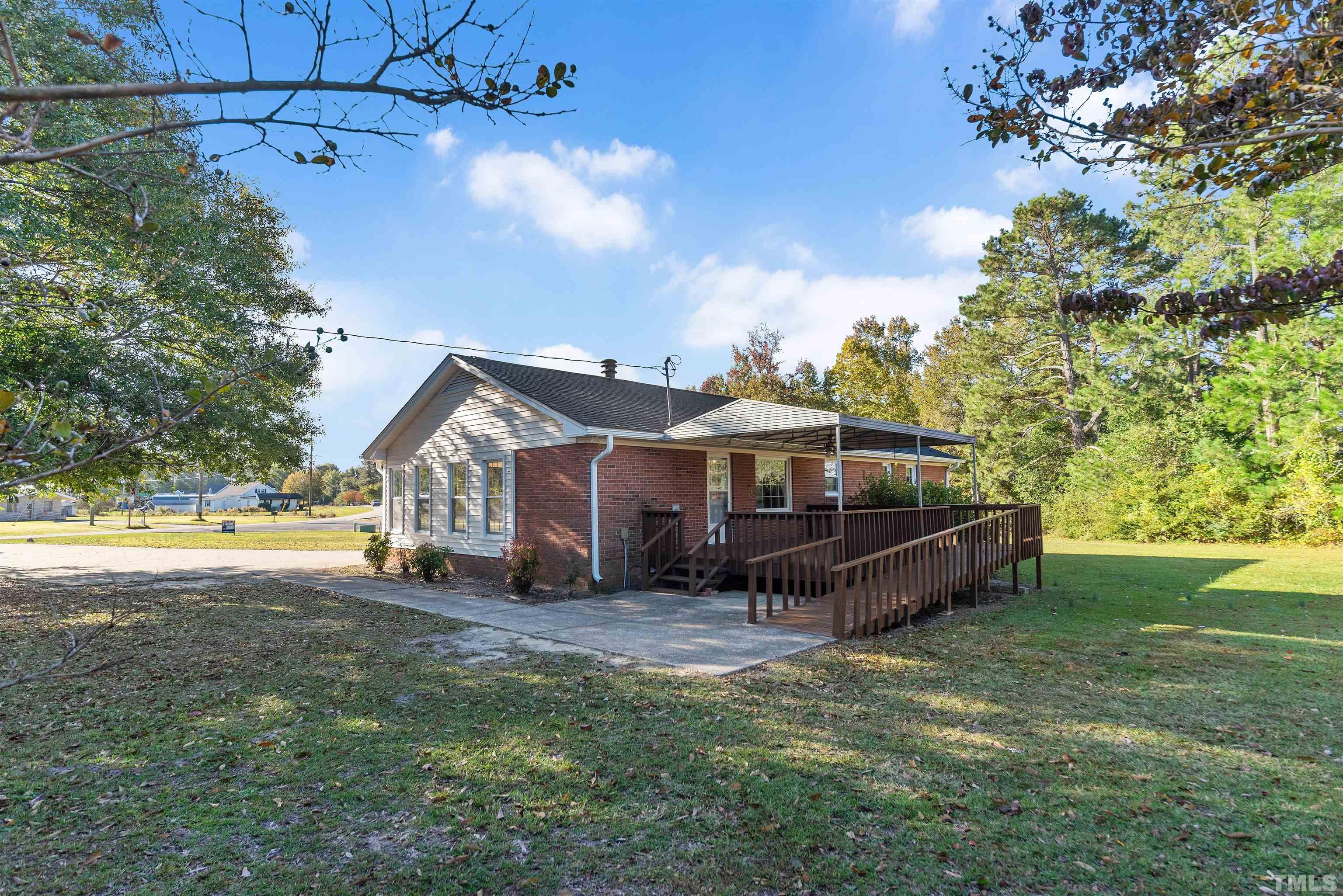 5630 Fairground Road Dunn, NC 28334 - Photo 30 of 33 a view of a house with a yard
