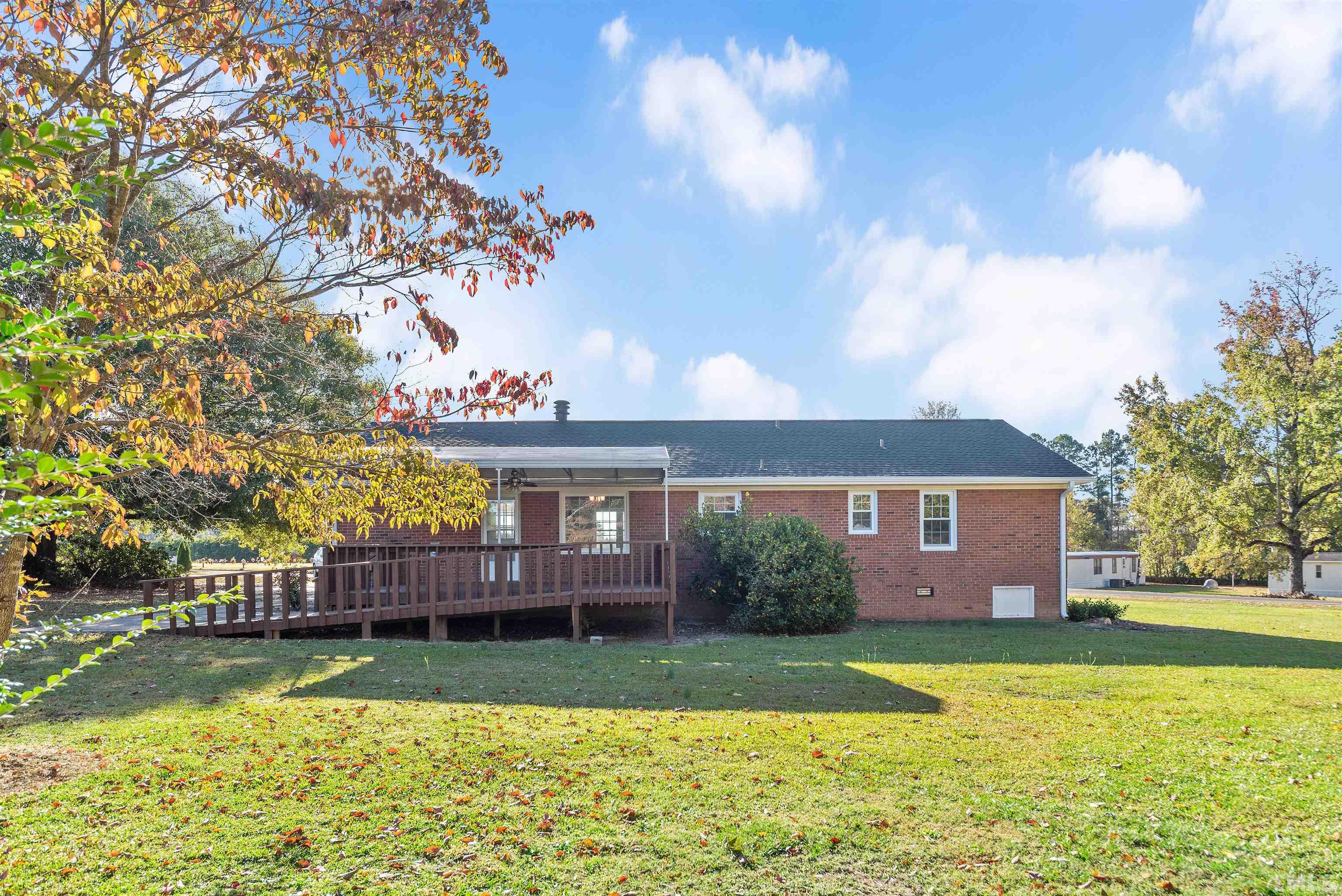 5630 Fairground Road Dunn, NC 28334 - Photo 31 of 33 a front view of a house with a garden and lake view
